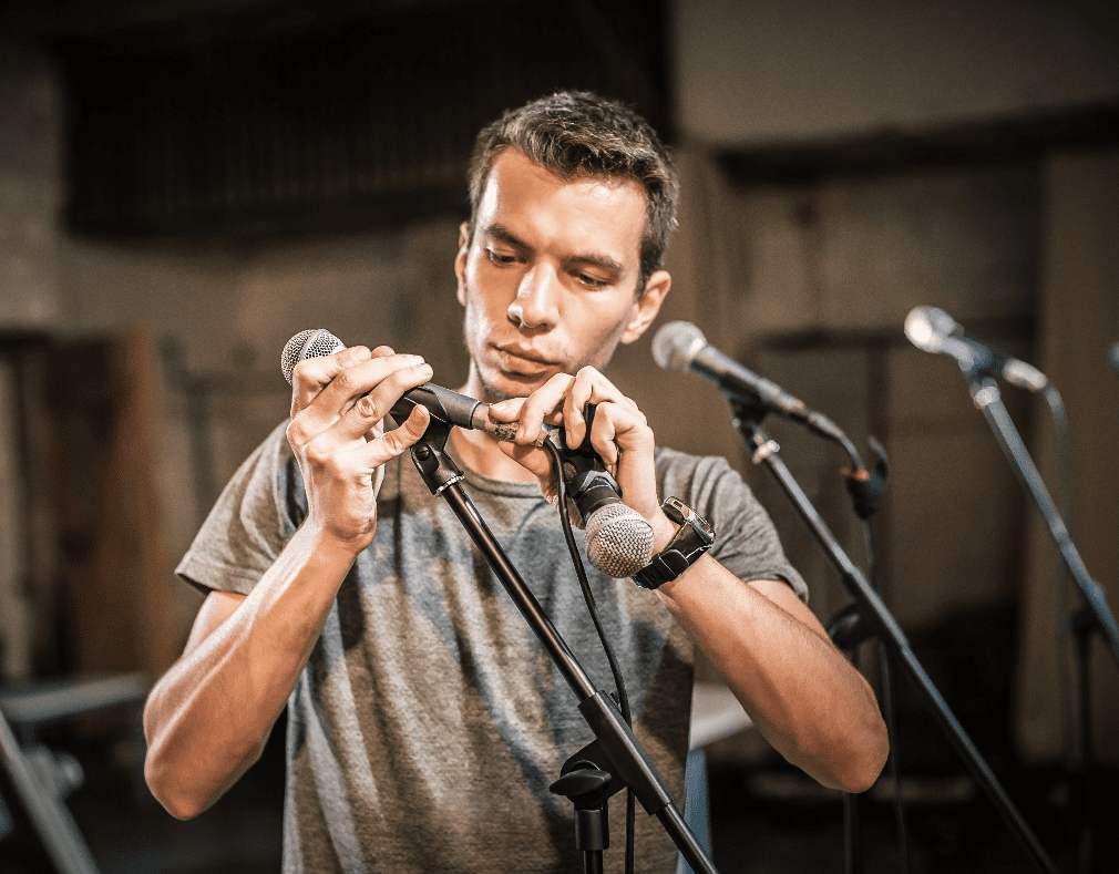 Man Adjusting Microphone